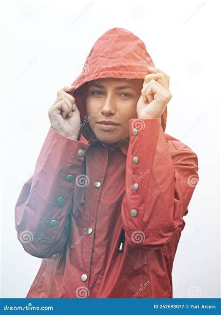 Caught in the rain. Cropped portrait of a young young woman pulling up