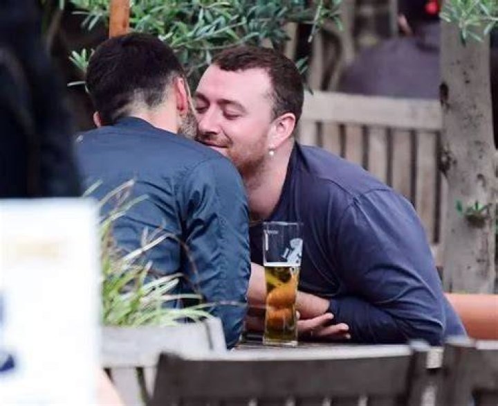 Sam Smith cuddles and snogs their new boyfriend in very passionate
