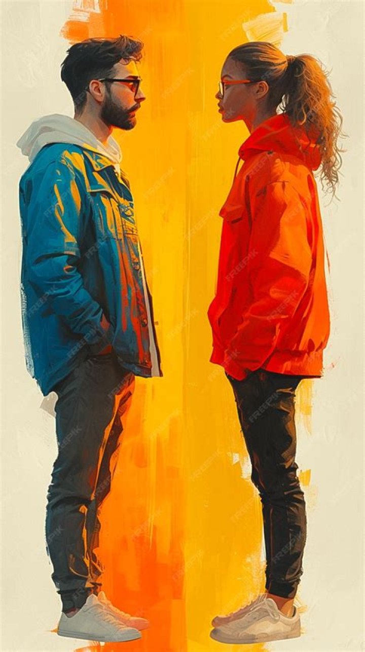 two people standing in front of a black backdrop